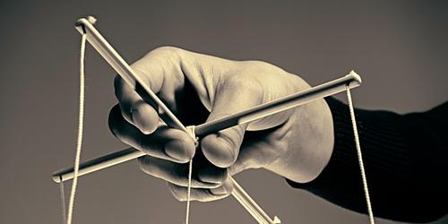 Person playing with puppet strings